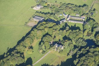 Oblique aerial view of House of Aquahorthies, walled garden, farmstead and Nether Mains of Aquahorthies, looking NW.