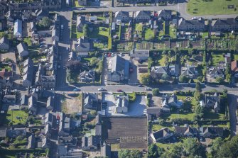 Oblique aerial view of Strathbogie Manse, TA Centre and Police Station, looking SSW.