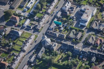 Oblique aerial view of St Margaret's School, St Margaret's Roman Catholic Church and Presbytery, looking E.