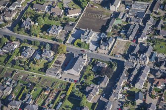 Oblique aerial view of Strathbogie Manse, TA Centre and Police Station, looking NNE.