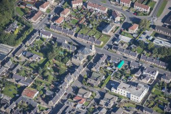 Oblique aerial view of St Margaret's School, St Margaret's Roman Catholic Church and Presbytery, looking NNE.