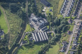 Oblique aerial view of Strathmill Distillery, looking SSW.