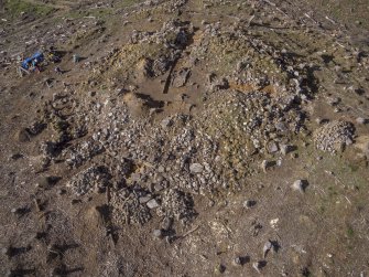 Post-excavation aerial photograph of the dun by Ed Martin, looking west-south-west over the east side of the dun and Trench 5; image shows the poorly defined outer wall face in the NE quadrant and the well-defined outer wall face in the SE quadrant, Comar Wood Dun, Cannich, Strathglass