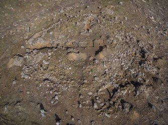 Post-excavation aerial photograph of the dun by Ed Martin, looking west-north-west over the south side of the dun and Trenches 4 and 6; image shows the well-defined outer wall face in the south east quadrant, particularly in Trench 4 (Structure 1), and the hearth in Trench 1, Comar Wood Dun, Cannich, Strathglass