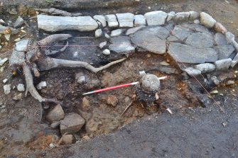 Post-excavation image after removal of south west section of hearth, showing remains of earlier hearth slabs underlying larger hearth, Comar Wood Dun, Cannich, Strathglass