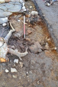 Post-excavation image after removal of south west section of hearth, showing remains of earlier hearth slabs underlying larger hearth, Comar Wood Dun, Cannich, Strathglass