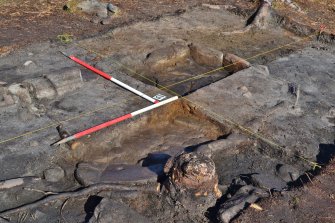 Mid-excavation image of the hearth in Trench 1 - showing base slabs and quernstone in situ, Comar Wood Dun, Cannich, Strathglass