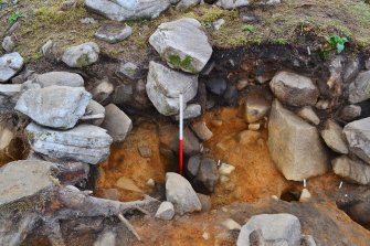 Large posthole inside dun courtyard (inner wall face and entrance passage to centre right), Comar Wood Dun, Cannich, Strathglass