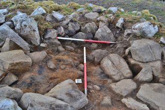 Burnt patches in possible intramural cell in dun wall, Trench 2; image shows smaller rubble fill within larger stones in east-south-east facing trench section, Comar Wood Dun, Cannich, Strathglass