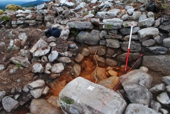 Post-excavation image showing dun outer wall and blocked-up passage, overlooking possible external wall, Comar Wood Dun, Cannich, Strathglass