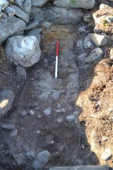 Post-excavation image of the trench through Structure 2, dun outer wall face in top centre, Comar Wood Dun, Cannich, Strathglass