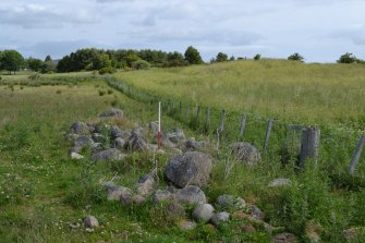 Shows the rectilinear clearance cairn (site 4) with the location of site 3 in the background, Torvean Golf Course, Sports Hub, Kilvean Cemetery