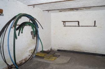 General view of west crew shelter with possible plinth for a stove, and hooks and original shelf.