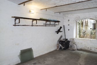 General view of west crew shelter with hooks and original shelf and coat hooks.