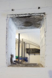 General view of light box between ammunition store and shell room showing ventilation holes.