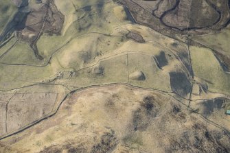 Oblique aerial view of the farmstead at Bad an Loin and the Grave of Diarmid four poster stone circle in Glen Shee, looking S.