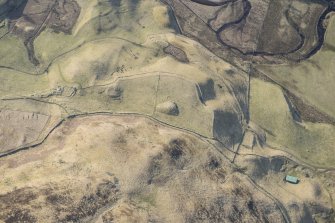 Oblique aerial view of the farmstead at Bad an Loin and the Grave of Diarmid four poster stone circle in Glen Shee, looking S.