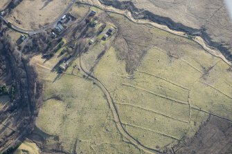 Oblique aerial view of the field system and rig and furrow to the SW of Spittal of Glenshee, looking SE.