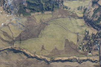 Oblique aerial view of the field system and rig and furrow to the SW of Spittal of Glenshee, looking NW.