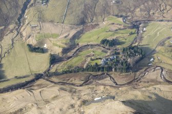 Oblique aerial view of Dalmunzie Hotel, depopulated township and the rig and furrow in the surrounding area, looking SSW.