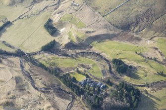 Oblique aerial view of Dalmunzie Hotel, depopulated township and the rig and furrow in the surrounding area, looking SSW.