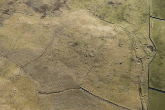 Oblique aerial view of the Ashintully township and Cnoc an Dainmh hut circles, looking SE.