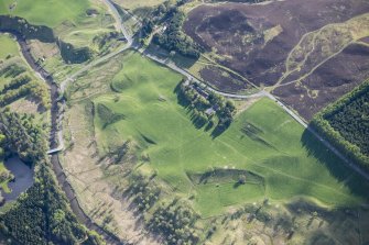 Oblique aerial view of a farmstead, enclosures and rig and furrow at Lair in Glen Shee, looking SW.