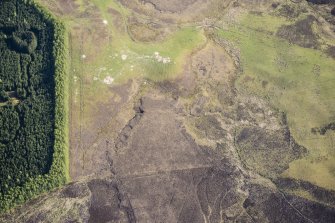 Oblique aerial view of a Pitcarmick building and cultivation remains at Lair in Glen Shee, looking S.