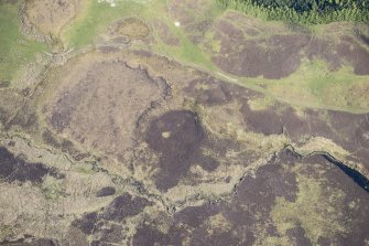 Oblique aerial view of Pitcarmick buildings, hut circles and rig at Lair in Glen Shee, looking NNE.