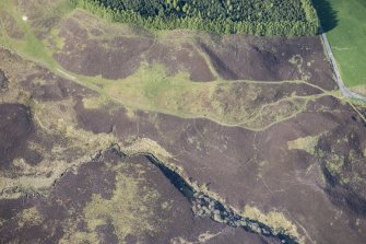 Oblique aerial view of Pitcarmick buildings, hut circles and ring cairn at Lair in Glen Shee, looking NNE.