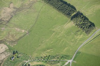 Oblique aerial view of the townships, field system and rig at Gleann Fearnach on the slopes of Creag Dubh Leitir, looking E.