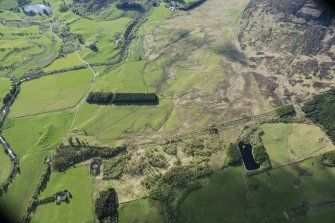 Oblique aerial view of the cairnfield, enclosures and rig at Gleann Fearnach on the slopes of Creag Dubh Leitir, looking NW.