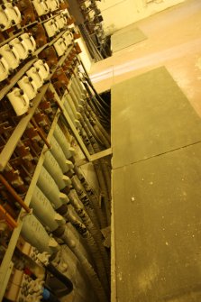 LV feeder switches and holes in floor, photograph from desk-based assessment and historic building survey of Fort House, Leith, Edinburgh