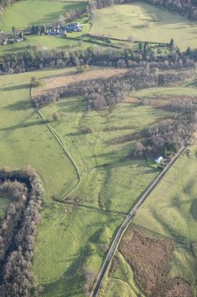 Oblique aerial view of the small cairns at Wester Buchanty with Glenalmond House beyond, looking E.