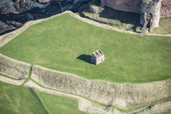 Oblique aerial view of Tantallon Castle centred on the dovecot, looking NE.