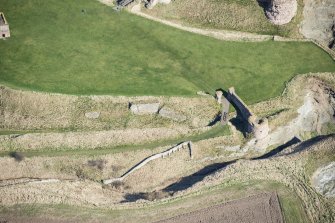Oblique aerial view of the entrance through the outerworks at Tantallon Castle, looking NNE.