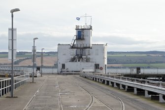 Control tower at end of pier, general view from north. Rail lines for greight traffic  also visible.