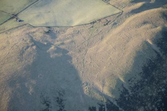 Oblique aerial view of the township, field system, hut circles, ring cairns and cairnfield on Strone Hill, looking SW.