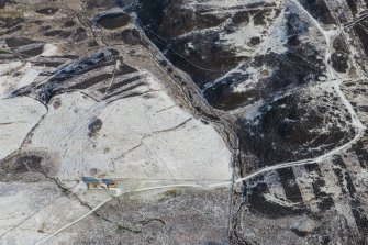 Oblique aerial view of the hut circles, buildings, field system and rig at Craigend, looking NNE.