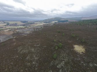 Oblique aerial view overlooking hut circle E and adjacent hollow ways, looking NE.