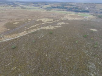 Oblique aerial view centred on what may be the remains of a hut circle at NH 7304 3813