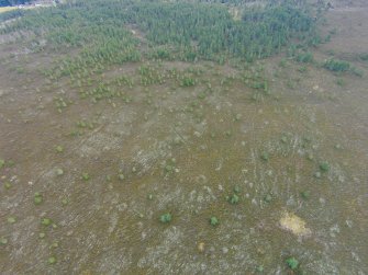 General oblique aerial view of the hut circles, hollow ways and field system, looking SE.