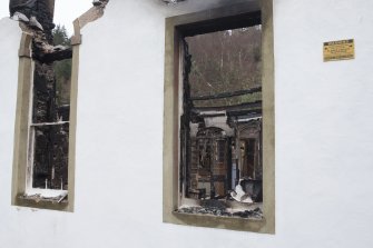 Detail of window showing interior damage.