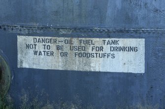 Detail of painted sign at base of fuel tank