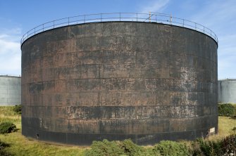 Former brick clad fuel tank, view from south west. Removed brick cladding (anti blast measure) can be seen in the patina of the metal tank wall