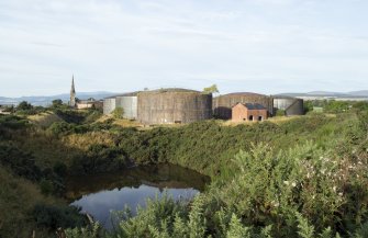 Fuel tanks, general view from south east. Note two tanks (nos. 6 and 7 of 10) dating from the first phase (c.1912/13) pre-First World War period with brick cladding (anti blast measure from Second World War period).