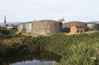Fuel tanks, view from south east. Note two tanks (nos. 6 and 7 of 10) dating from the first phase (c.1912/13) pre-First World War period with brick cladding (anti blast measure from Second World War period).