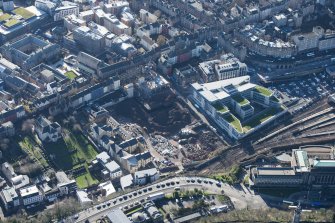 Oblique aerial view of the Caltongate Development and Waverley Court, looking SW.