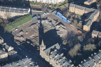 Oblique aerial view of the construction of student flats in St Leonards Street and the Roman Catholic Church of St Margaret and St Leonard, looking N.