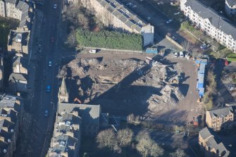 Oblique aerial view of the construction of Student flats in St Leonard's Street and the Roman Catholic Church of St Margaret and St Leonard, looking NW.